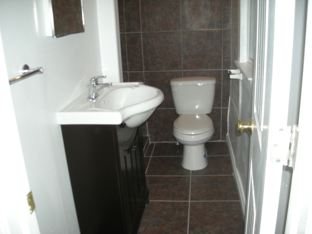 Half bath featuring vanity and tile patterned flooring