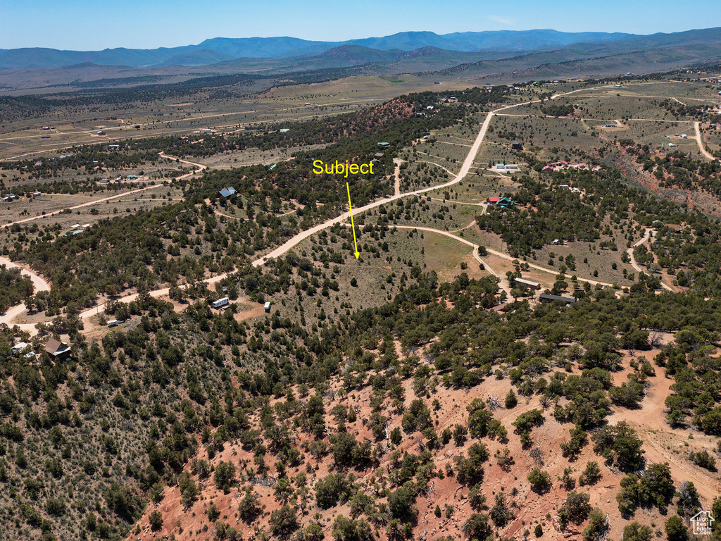 Aerial view of sparsely populated area with mountains and a desert landscape
