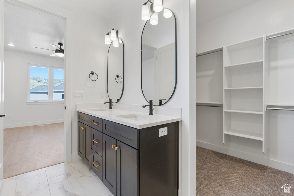 Bathroom featuring ceiling fan and double vanity