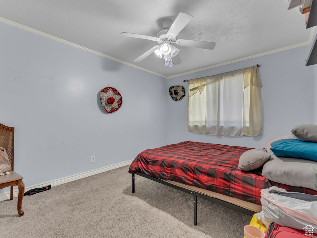 Bedroom featuring carpet, crown molding, and ceiling fan