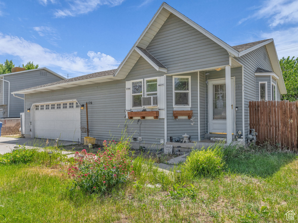 View of front of house with a garage and concrete driveway