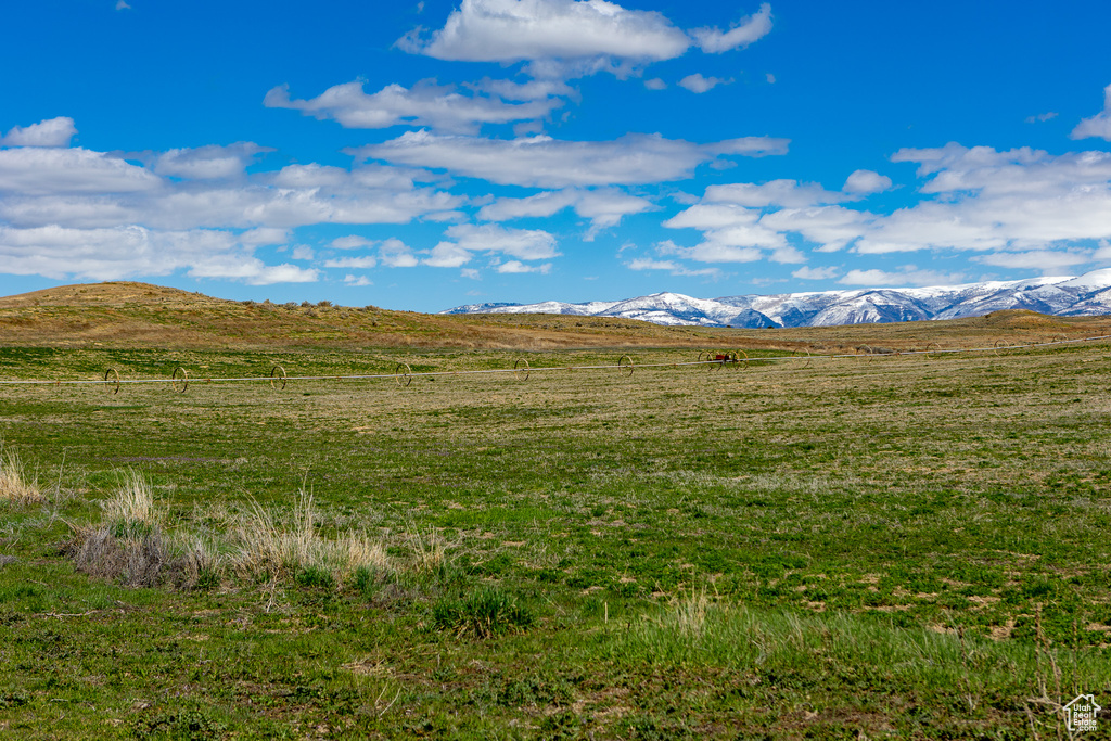 View of mountain backdrop with rural landscape