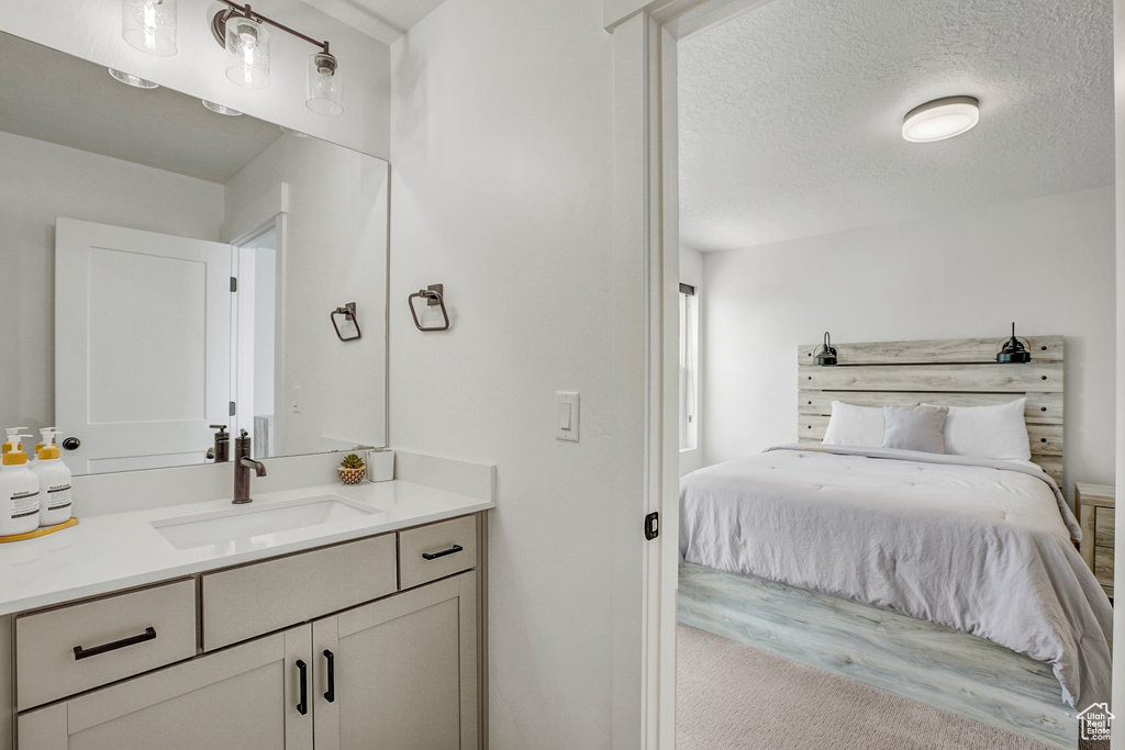 Ensuite bathroom with vanity and a textured ceiling