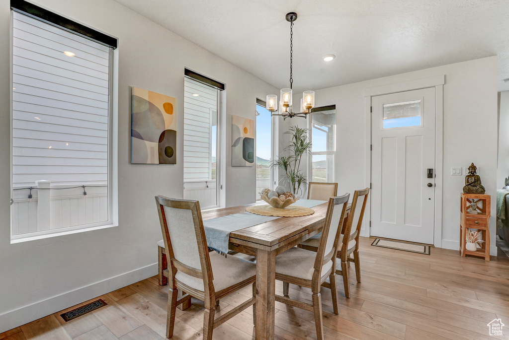 Dining space featuring a chandelier and light wood-style flooring