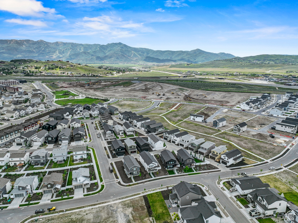 Aerial view of property and surrounding area with nearby suburban area