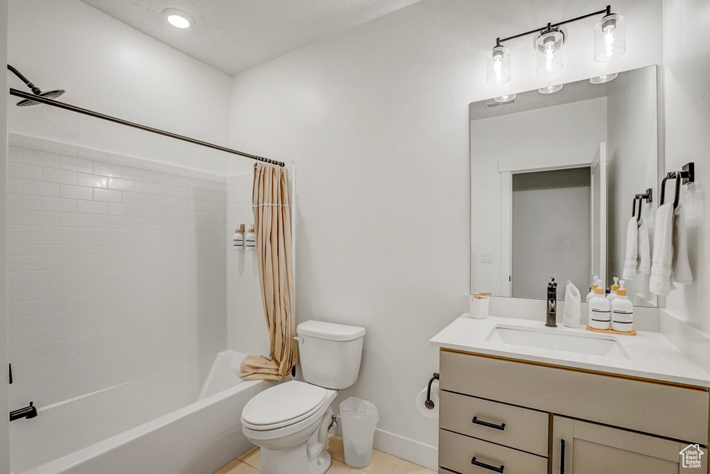 Full bath featuring vanity, shower / bath combination with curtain, and tile patterned flooring