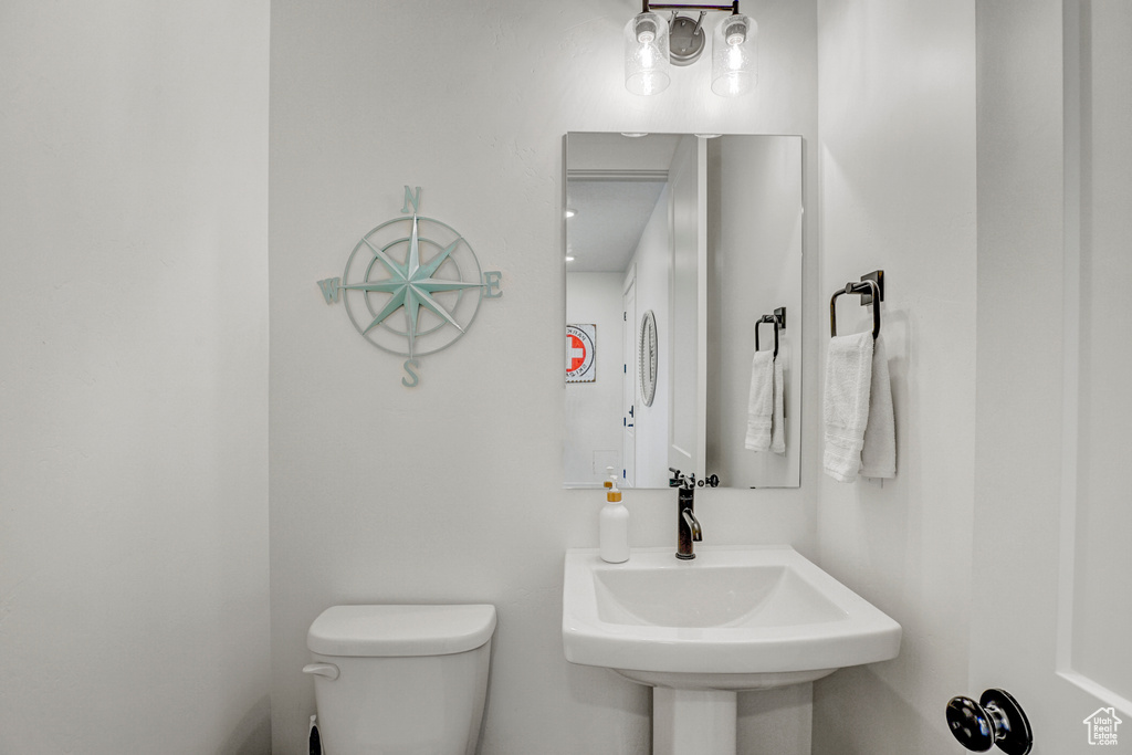 Half bath with toilet and a sink