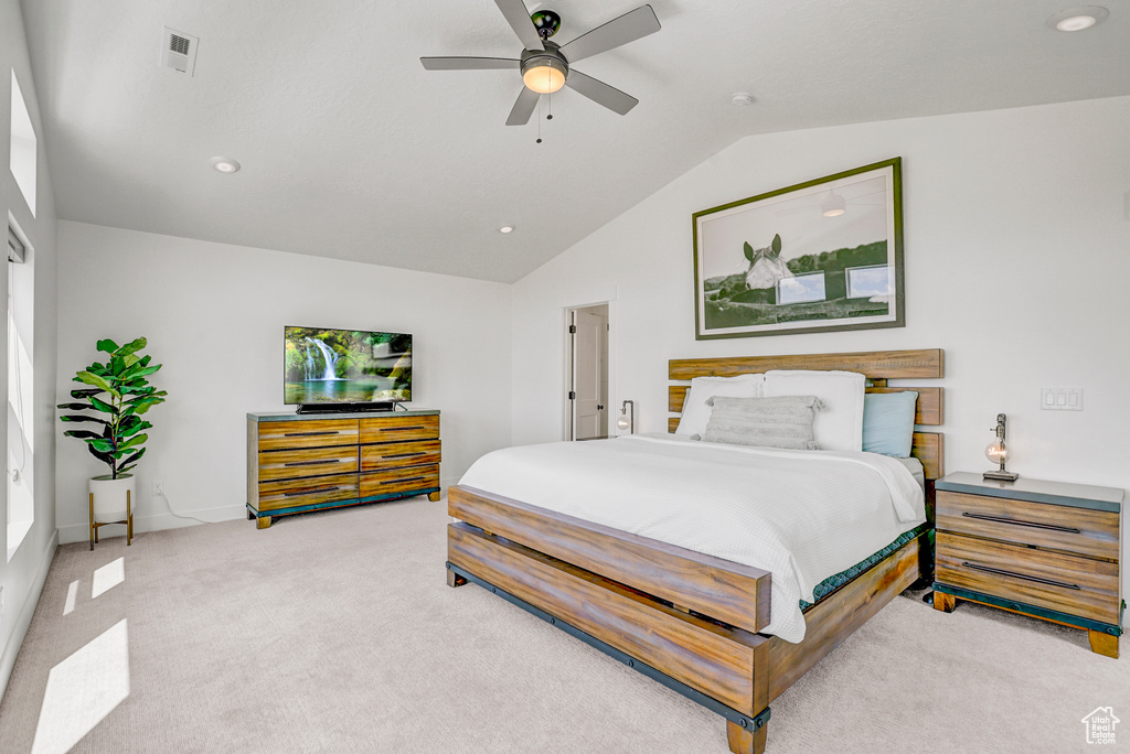 Bedroom with vaulted ceiling, light carpet, a ceiling fan, and recessed lighting