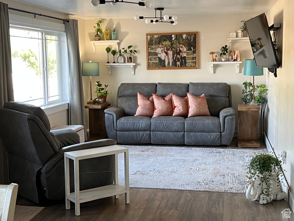 Living room with wood finished floors and a chandelier