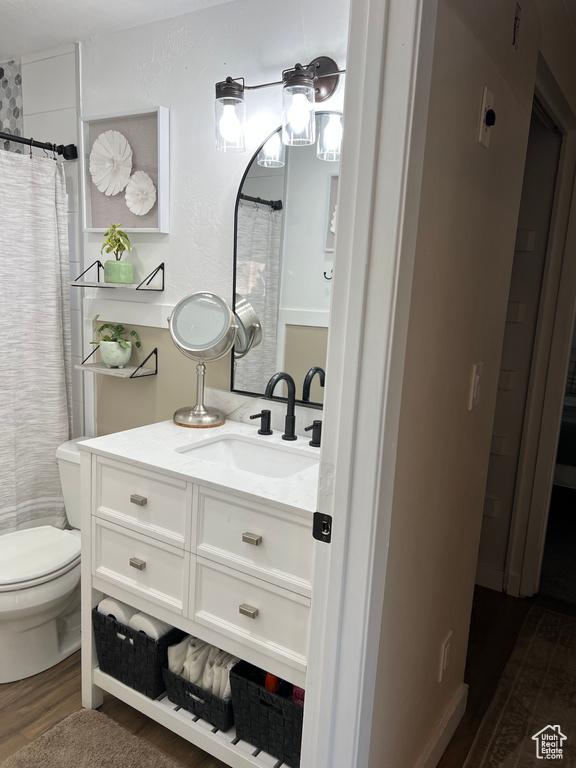 Full bathroom with wood finished floors and vanity