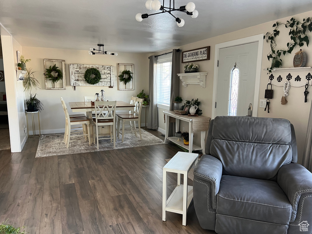 Dining room with a chandelier and dark wood finished floors