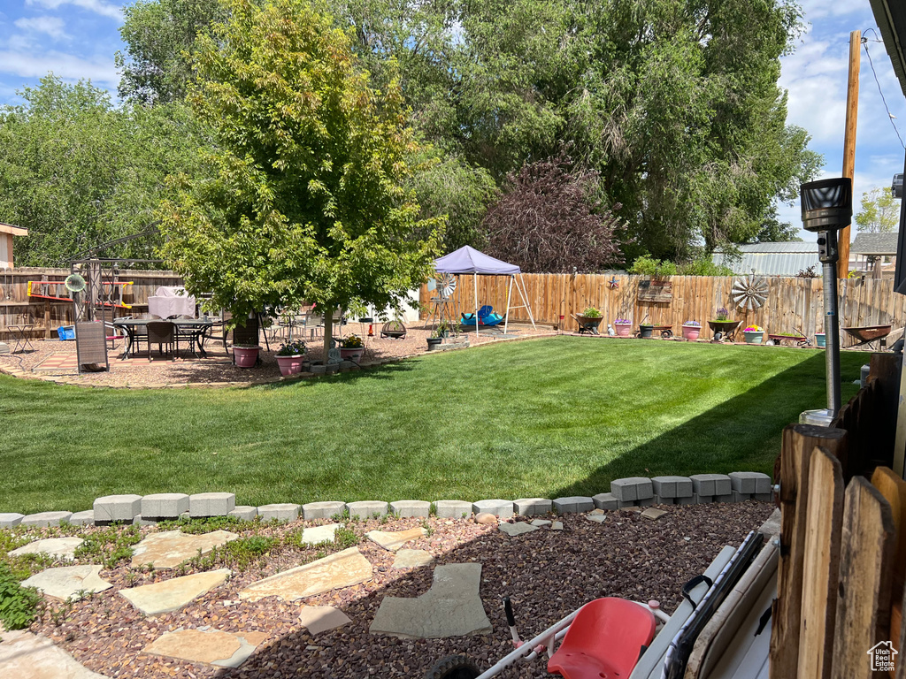 Fenced backyard with a playground