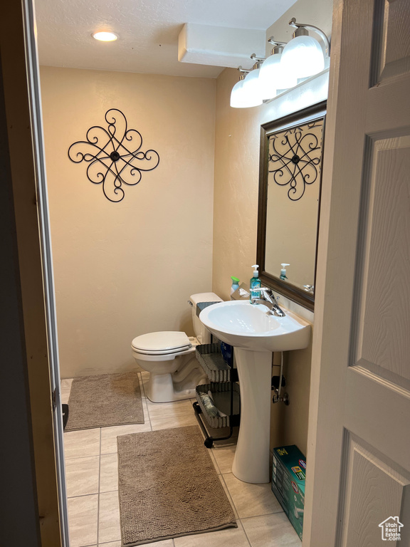 Half bathroom with tile patterned floors
