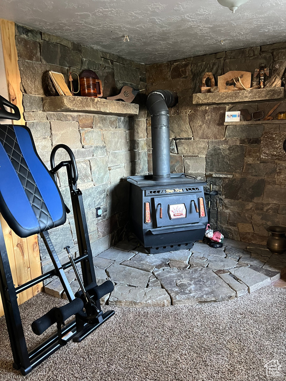Detailed view of a wood stove and a textured ceiling