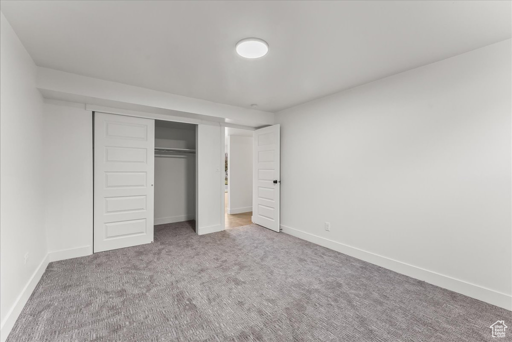 Unfurnished bedroom with carpet floors and a closet