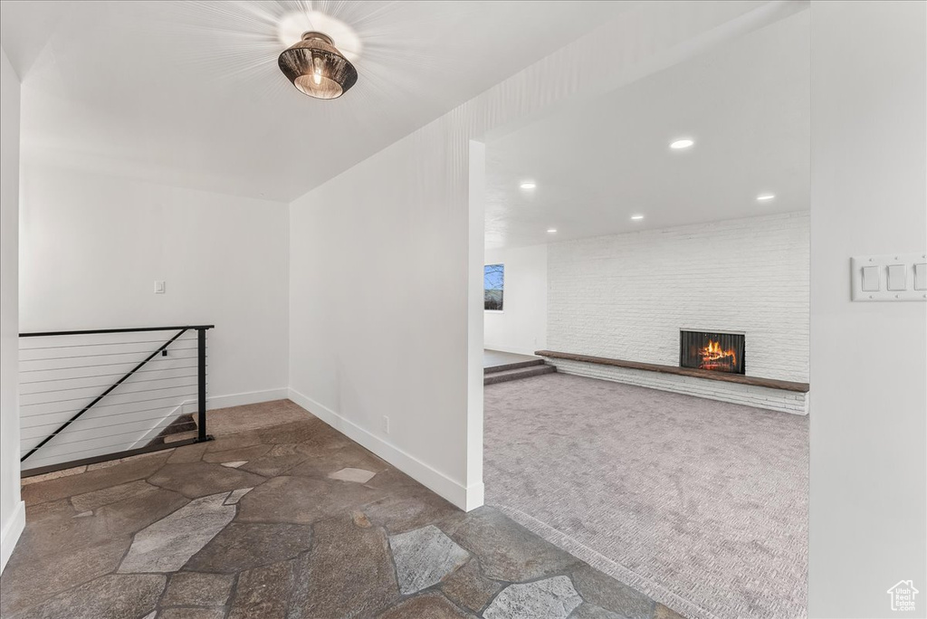 Hallway featuring an upstairs landing, recessed lighting, and carpet floors