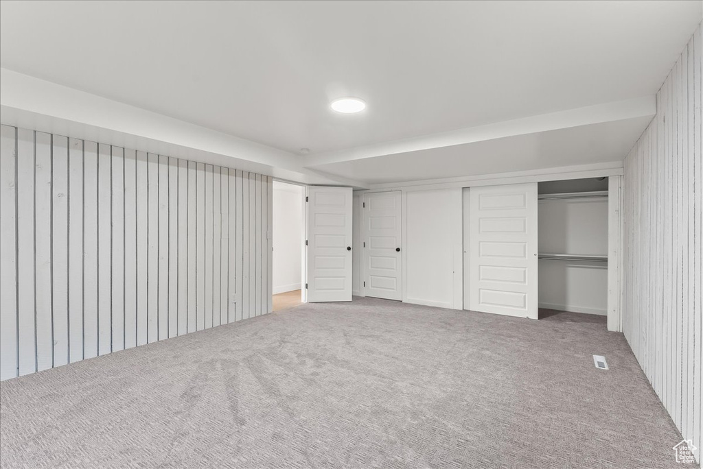 Unfurnished bedroom featuring carpet and a closet