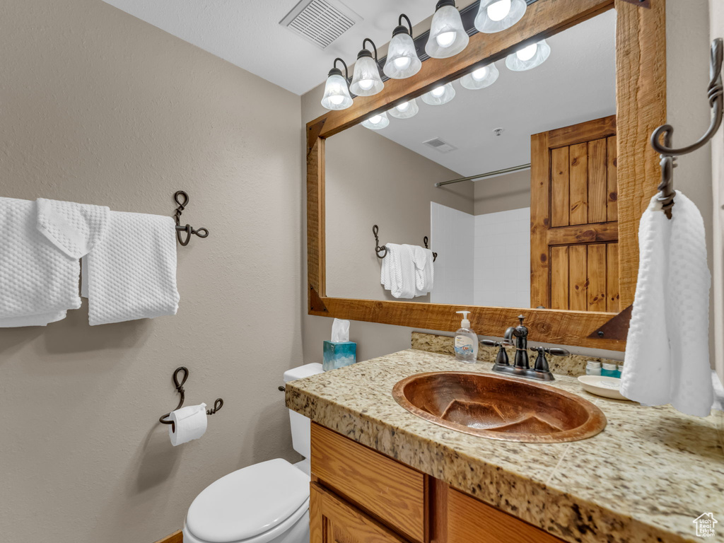 Bathroom with vanity and a shower