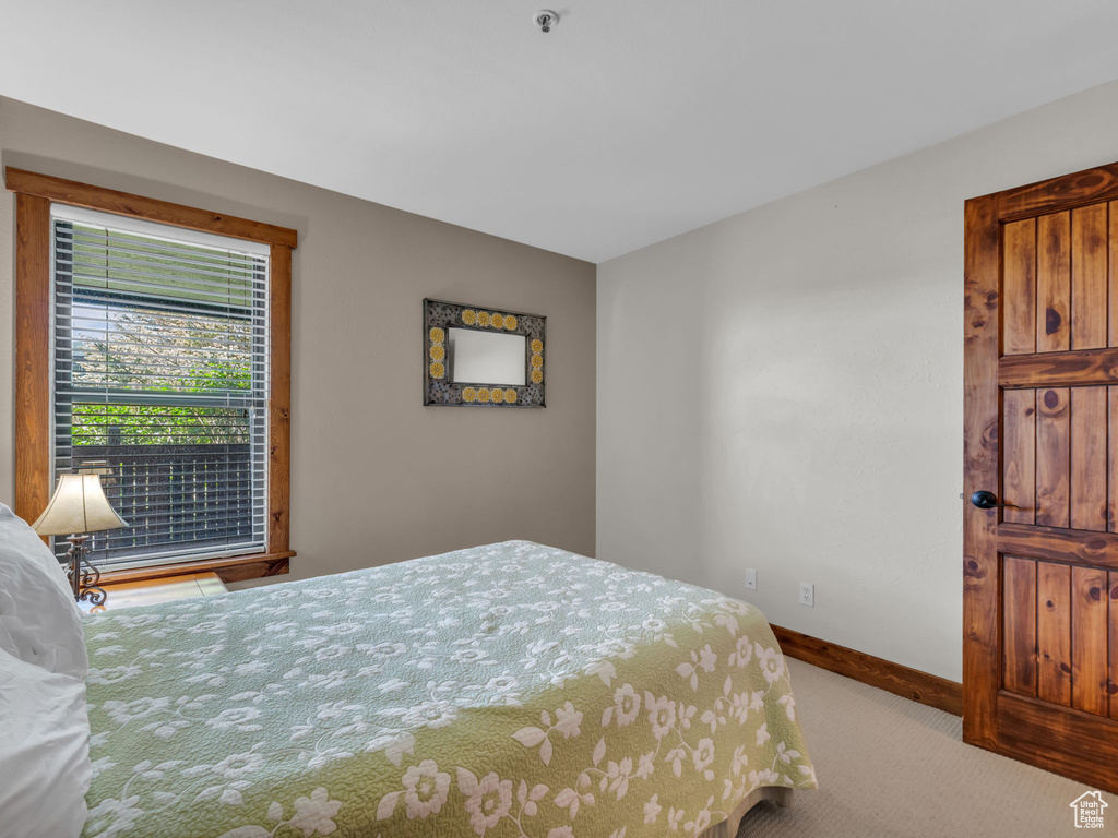 Bedroom featuring carpet flooring and baseboards
