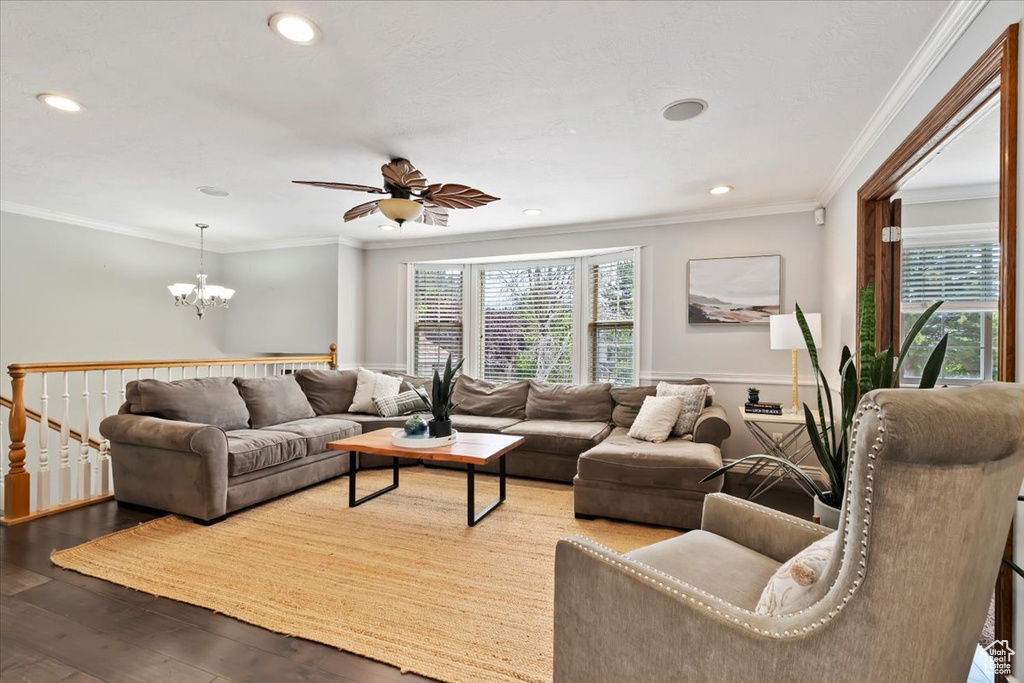 Living room featuring a chandelier, crown molding, hardwood / wood-style flooring, recessed lighting, and a ceiling fan