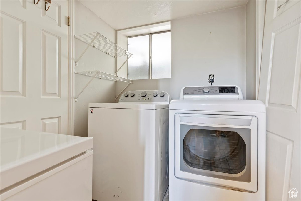 Laundry room with washer and clothes dryer