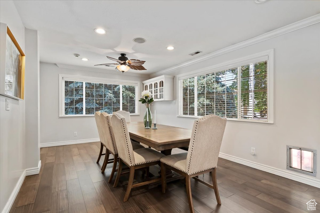 Dining room featuring ornamental molding, ceiling fan, dark wood finished floors, and recessed lighting