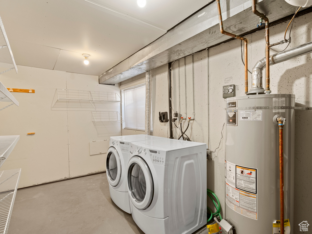 Laundry room with gas water heater and washing machine and dryer