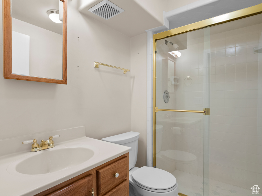 Full bath with a stall shower and vanity