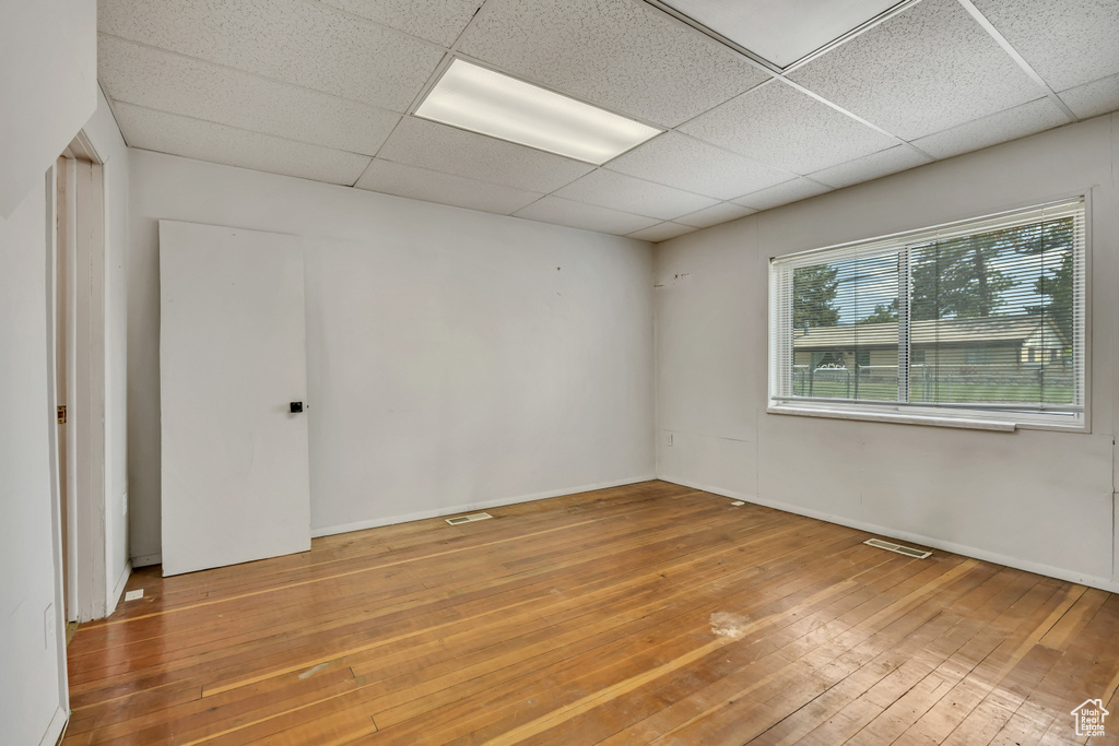 Spare room featuring hardwood / wood-style floors and a drop ceiling