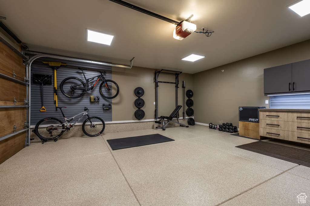 Workout room with a garage and baseboards