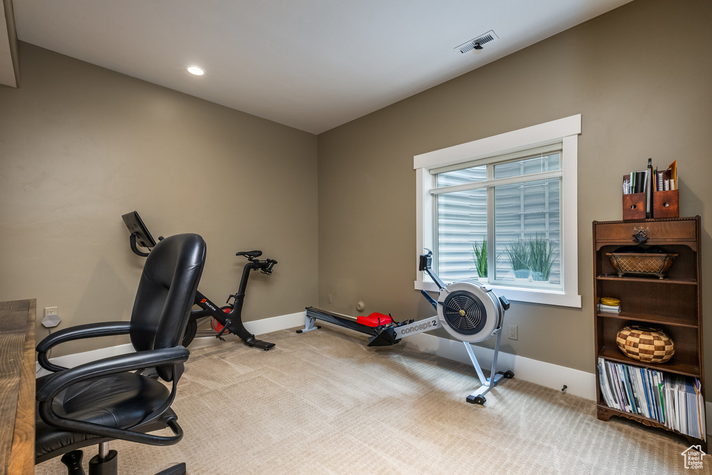 Exercise area with carpet flooring and recessed lighting