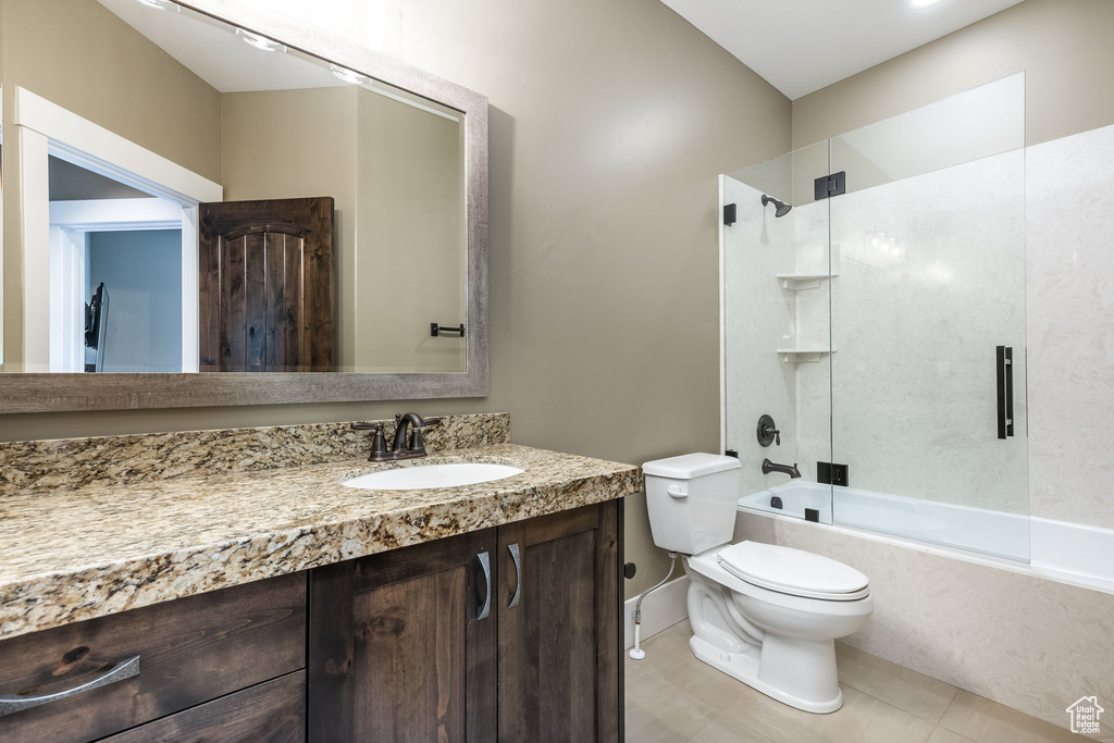 Bathroom with enclosed tub / shower combo, vanity, and tile patterned floors