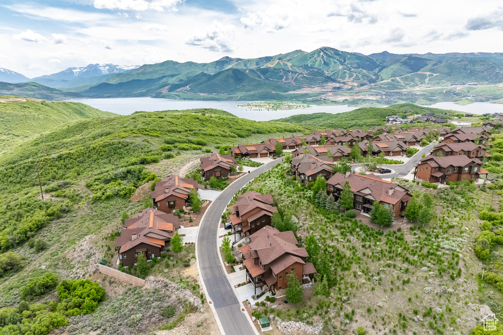 Aerial view of property's location featuring nearby suburban area and a water and mountain view