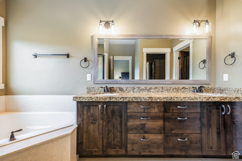 Bathroom featuring double vanity and a garden tub