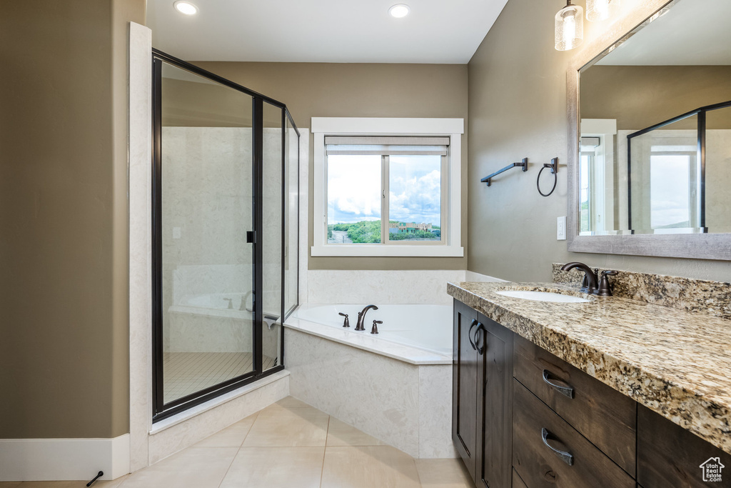 Bathroom with vanity, a garden tub, a stall shower, tile patterned flooring, and recessed lighting