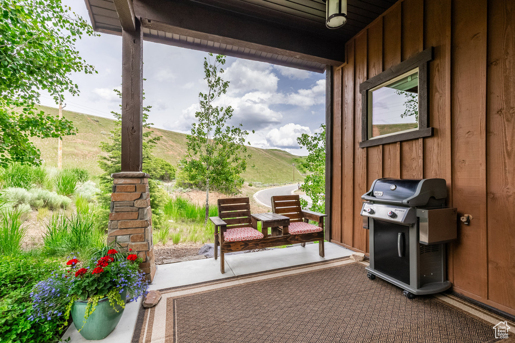 View of patio with a grill