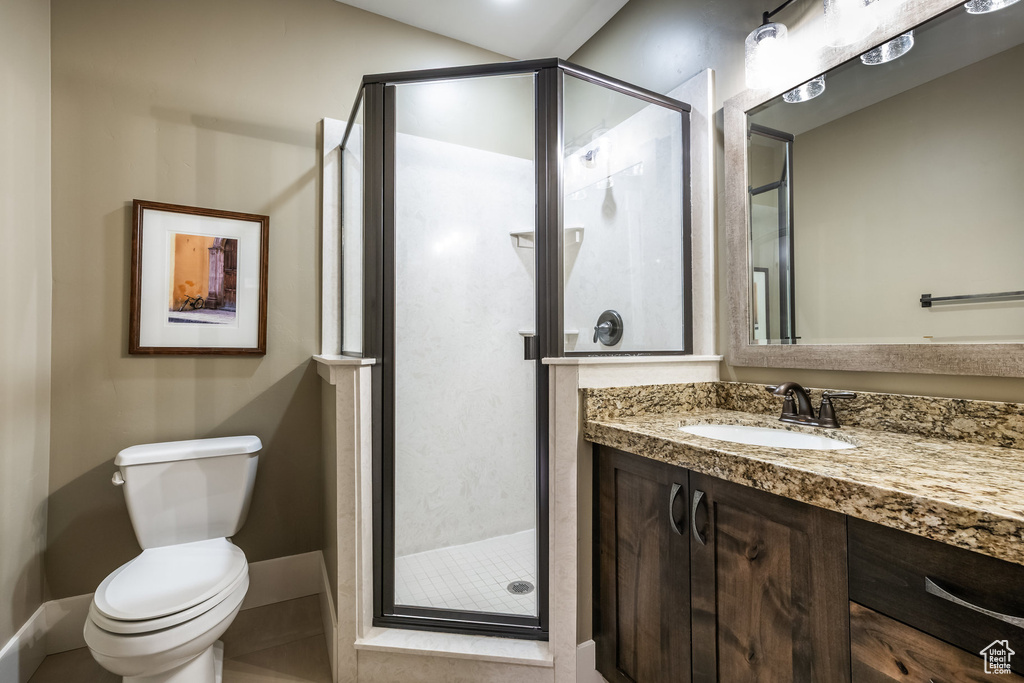 Full bathroom with vanity and a stall shower