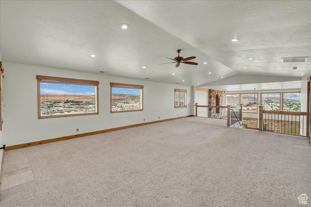Unfurnished living room featuring ceiling fan, vaulted ceiling, carpet floors, and recessed lighting