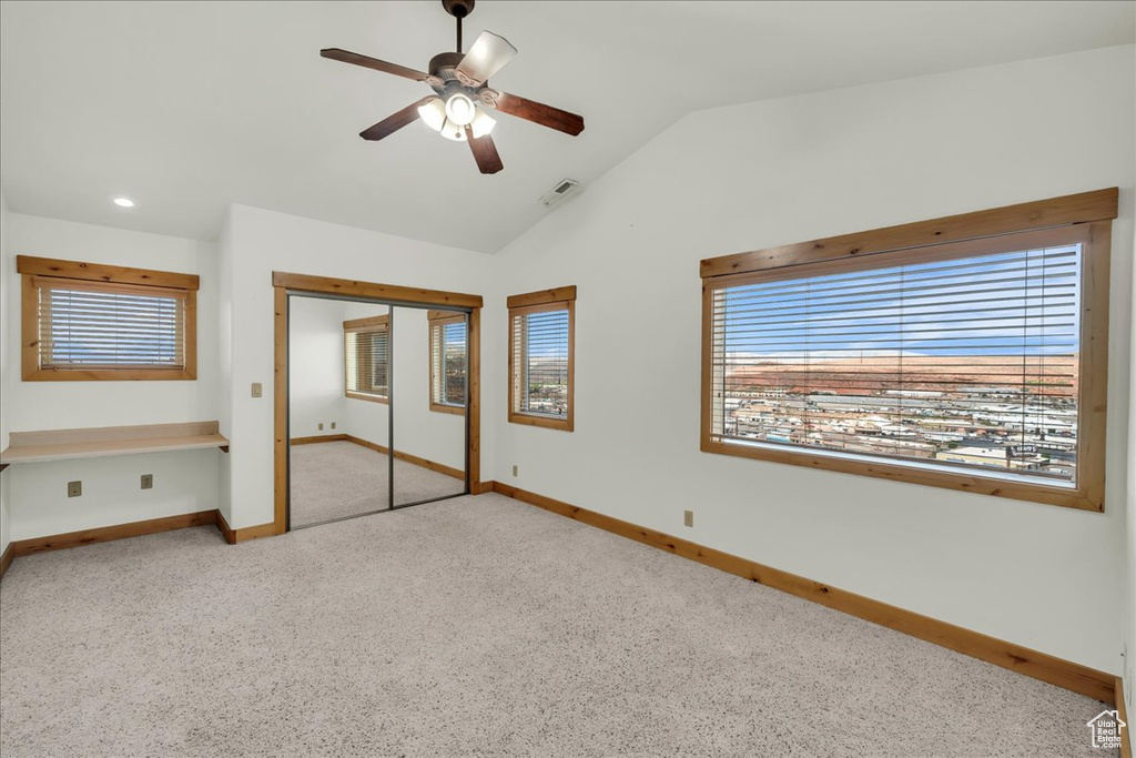 Unfurnished bedroom with carpet flooring, vaulted ceiling, a closet, recessed lighting, and a ceiling fan