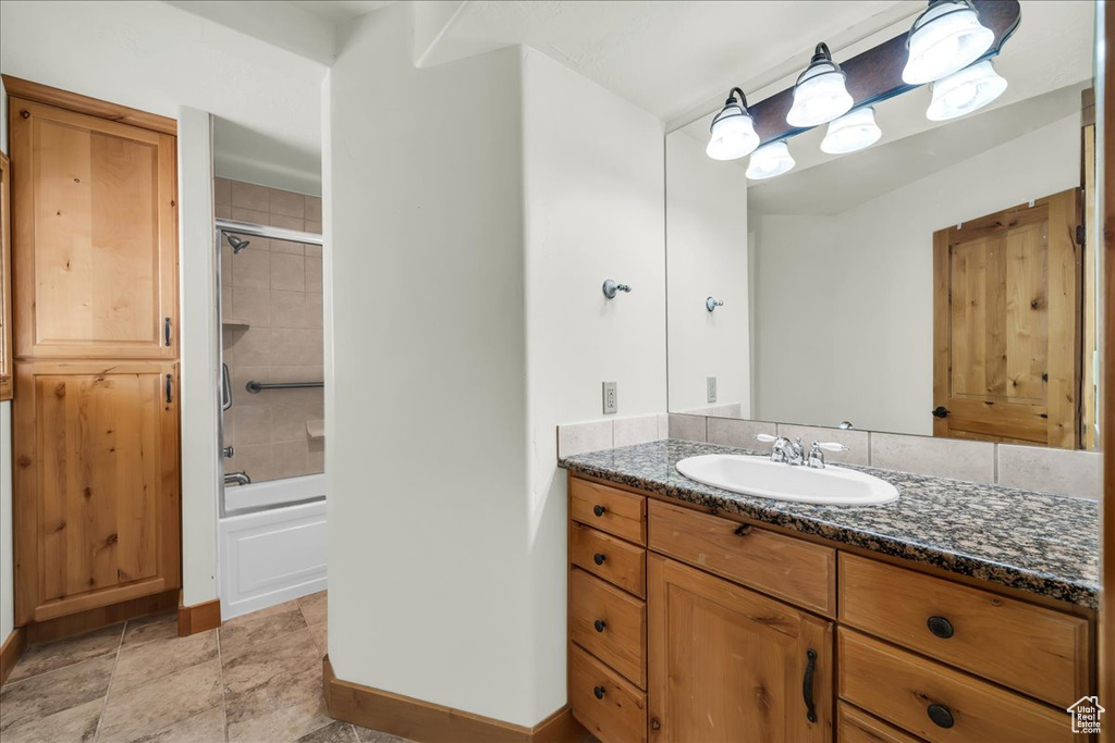 Bathroom with vanity and  shower combination