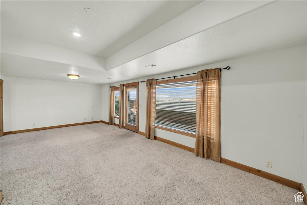 Spare room with light colored carpet
