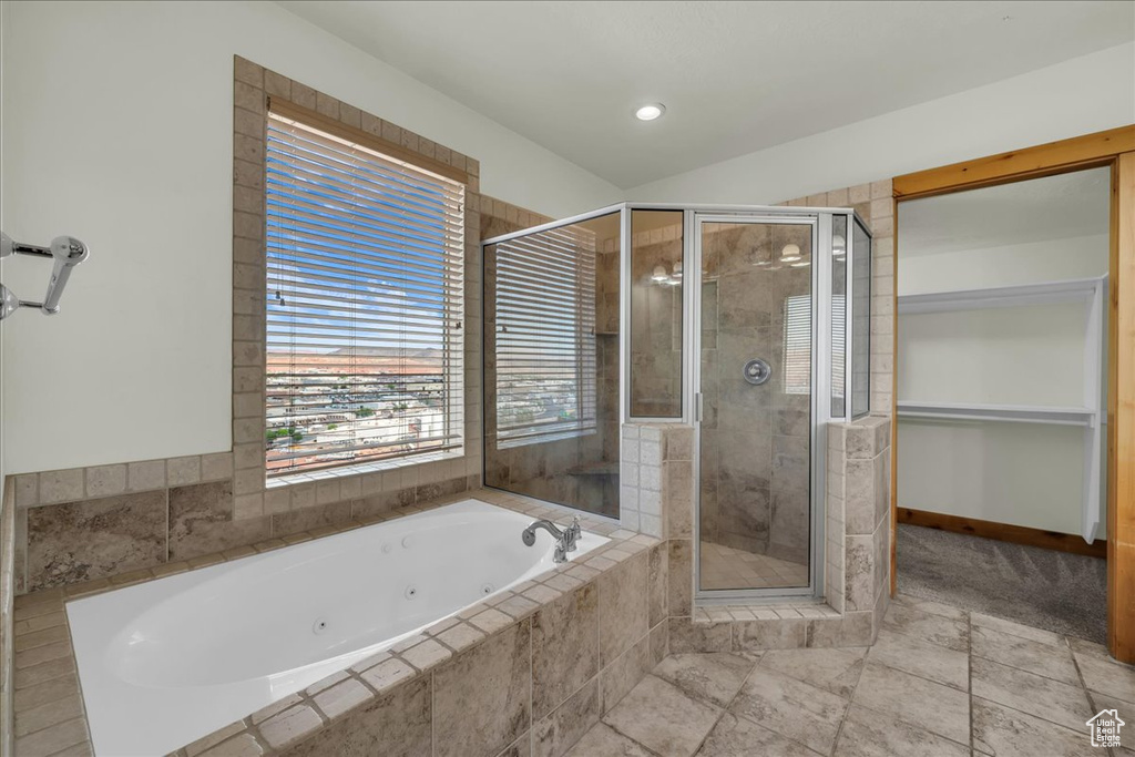 Full bathroom with a tub with jets and a stall shower