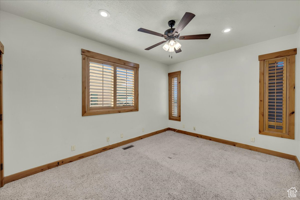 Unfurnished room featuring carpet flooring, ceiling fan, and recessed lighting
