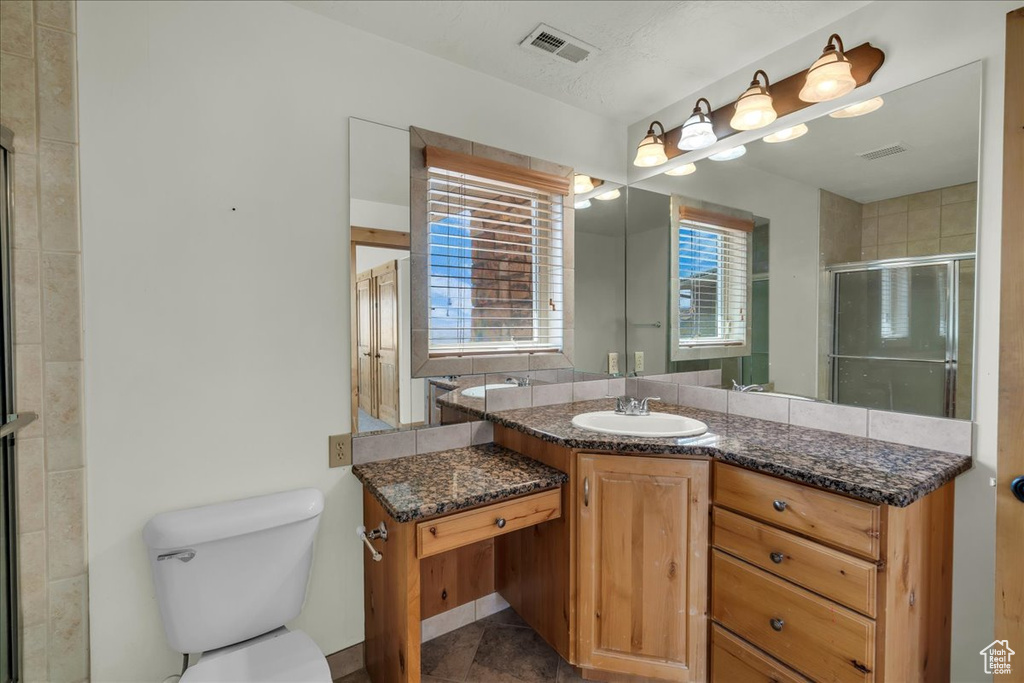 Full bath featuring vanity and a shower stall