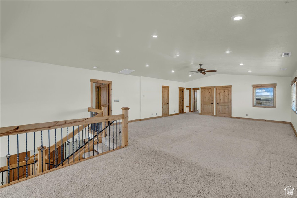 Empty room with vaulted ceiling, recessed lighting, ceiling fan, and light colored carpet