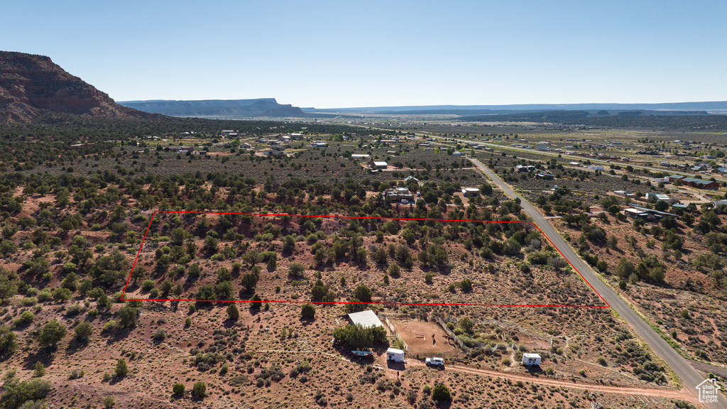View of rural area featuring a mountain backdrop and a desert landscape