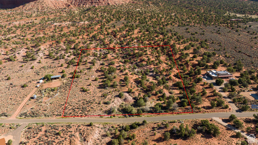 Aerial view of sparsely populated area with property parcel outlined
