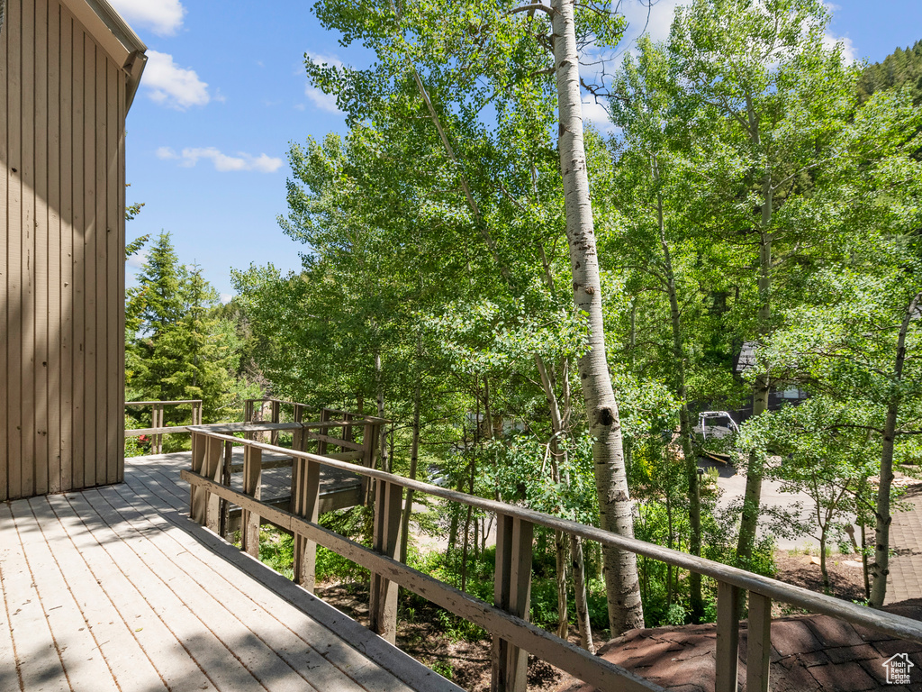 Deck featuring view of wooded area