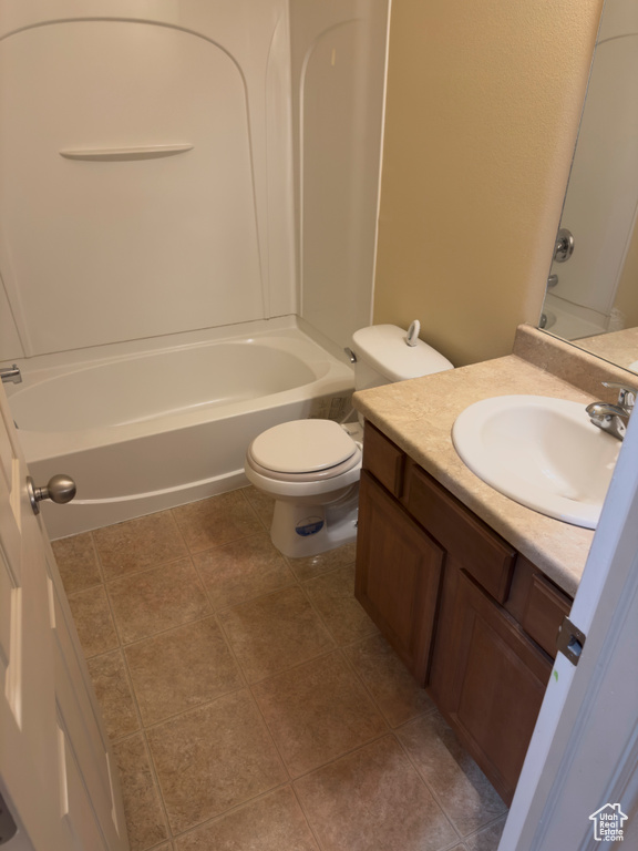 Bathroom featuring vanity, bathtub / shower combination, and tile patterned floors