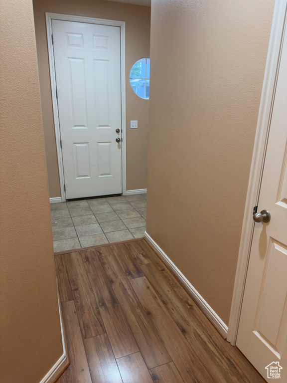 Doorway to outside with baseboards and light wood-style floors